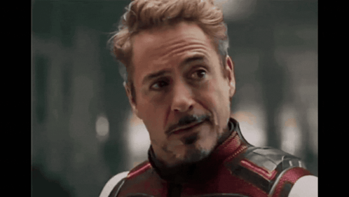 A Close Up Of A Man With A Beard Wearing A Superhero Costume And Looking At The Camera . GIF