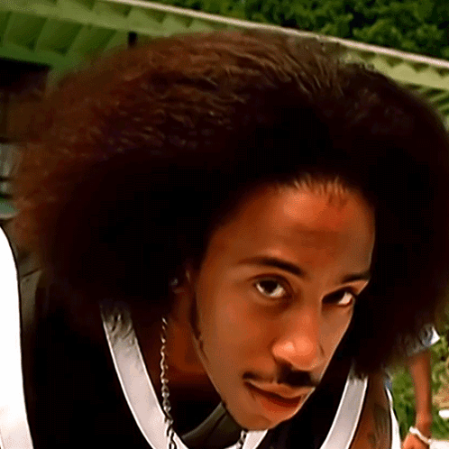 A Close Up Of A Man With A Big Afro GIF