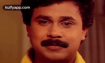 A Close Up Of A Man With A Fake Mustache On His Face . GIF