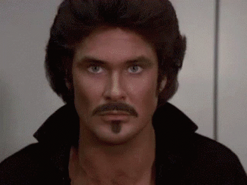 A Close Up Of A Man With A Mustache And A Wig GIF