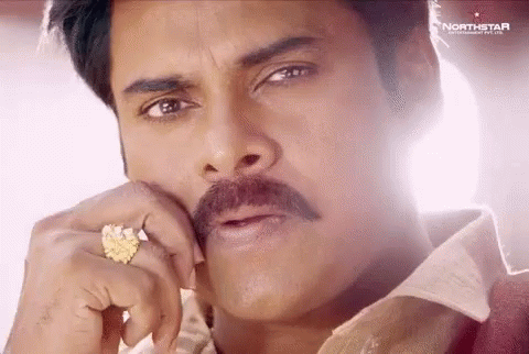 A Close Up Of A Man With A Mustache Wearing A Ring On His Finger . GIF