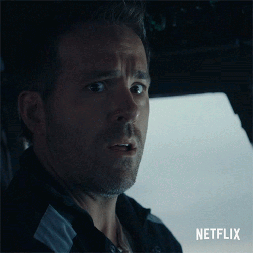A Close Up Of A Man With A Netflix Logo Behind Him GIF