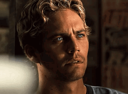 A Close Up Of A Man With Blue Eyes And Blonde Hair GIF