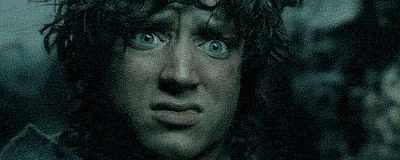 A Close Up Of A Man With Blue Eyes Making A Funny Face In The Dark . GIF