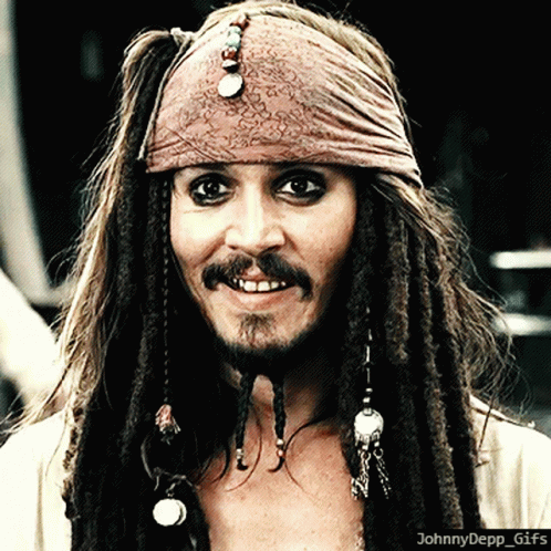 A Close Up Of A Man With Dreadlocks And A Bandana On His Head With The Caption Johnny Depp GIF