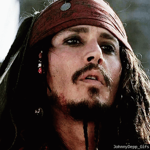 A Close Up Of A Man With Dreadlocks And A Scarf Around His Head GIF