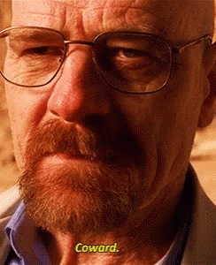 A Close Up Of A Man With Glasses And A Beard Says Coward GIF