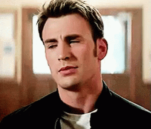 A Close Up Of A Man With His Eyes Closed Wearing A Black Jacket And A White Shirt . GIF