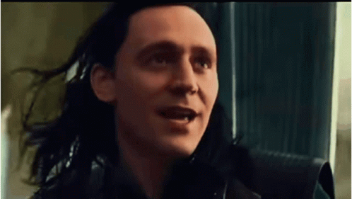 A Close Up Of A Man With Long Black Hair Making A Funny Face . GIF