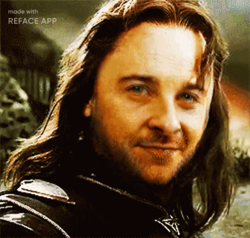 A Close Up Of A Man With Long Hair And A Beard . GIF