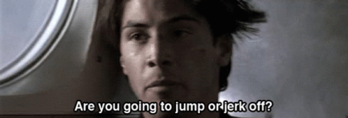 A Close Up Of A Man With The Words Are You Going To Jump Or Jerk Off Written Below Him GIF