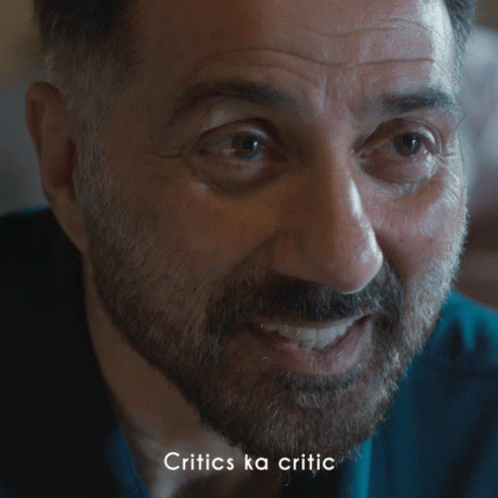 A Close Up Of A Man With The Words Critics Ka Critic Below Him GIF