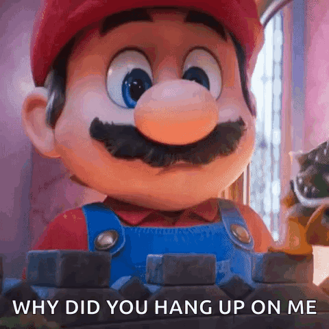A Close Up Of A Mario Mascot With The Words `` Why Did You Hang Up On Me '' Written On It . GIF