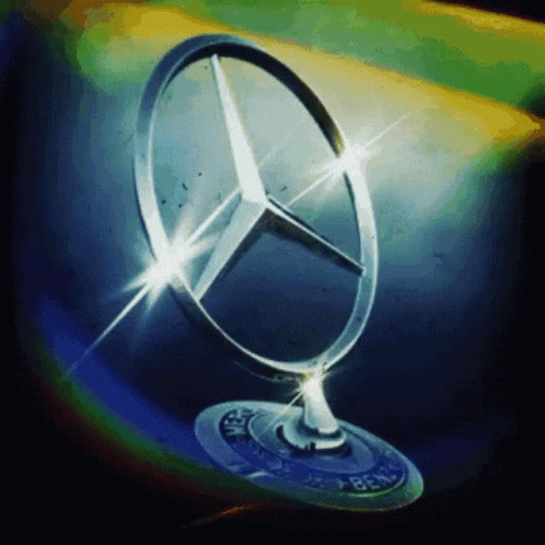 A Close Up Of A Mercedes Emblem On A Car Hood GIF