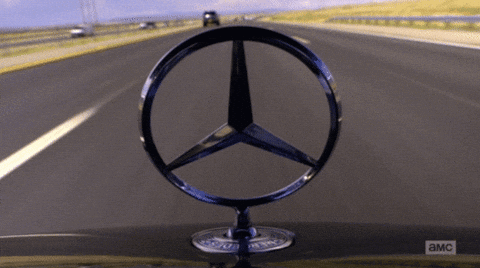 A Close Up Of A Mercedes Logo On A Car With A Blurred Background GIF