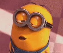 a close up of a minion wearing goggles and making a face .