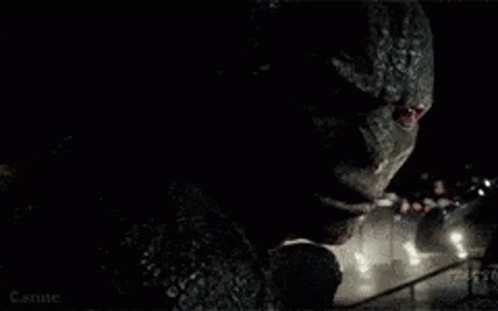 A Close Up Of A Monster 'S Face In The Dark GIF