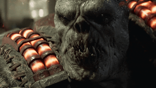 A Close Up Of A Monster 'S Face With A Bunch Of Red Balls In The Background GIF