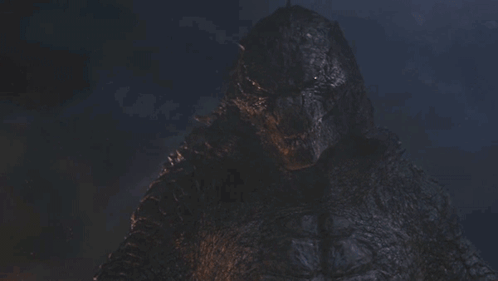 A Close Up Of A Monster 'S Face With A Dark Background GIF