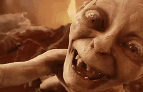 A Close Up Of A Monster 'S Face With A Flame Coming Out Of Its Mouth . GIF
