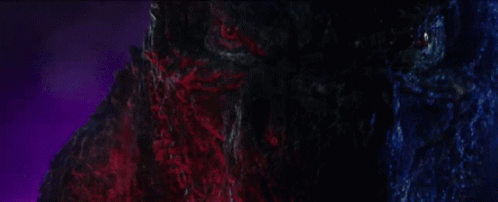 A Close Up Of A Monster 'S Face With Purple Lights Behind It GIF
