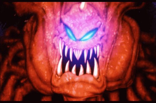 A Close Up Of A Monster 'S Mouth With Purple Eyes And Teeth GIF