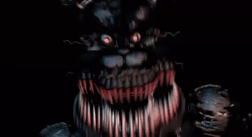 A Close Up Of A Monster With A Lot Of Teeth And Red Eyes . GIF