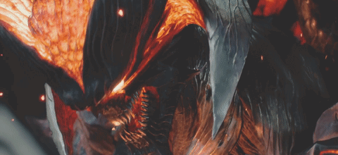 A Close Up Of A Monster With Flames Coming Out Of It 'S Mouth GIF