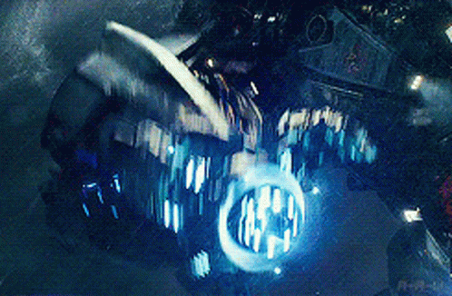 A Close Up Of A Motorcycle With A Blue Light Coming Out Of The Headlight GIF