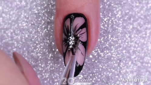 A Close Up Of A Nail With A Flower Design And The Words 20 Nails Made In Animatica GIF