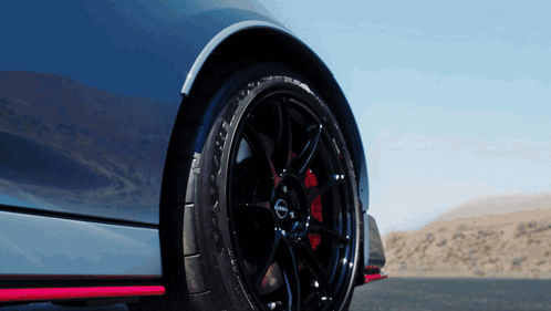 A Close Up Of A Nissan Car Wheel GIF