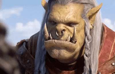 A Close Up Of A Orc With A Braided Hair Looking At The Camera GIF
