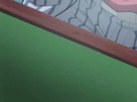 A Close Up Of A Pair Of Ice Cream Sticks On A Green Surface . GIF