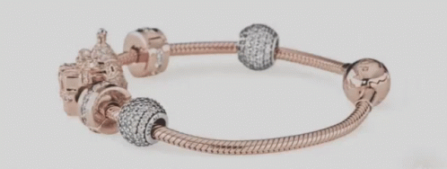 A Close Up Of A Pandora Bracelet With Various Charms On It GIF