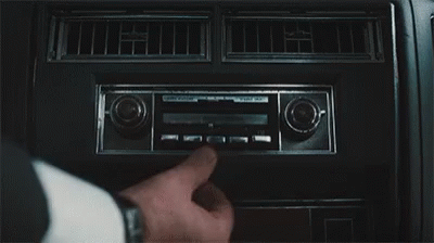 A Close Up Of A Person Adjusting A Radio In A Car . GIF
