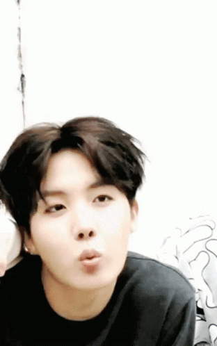 A Close Up Of A Person Blowing A Kiss With A White Background GIF