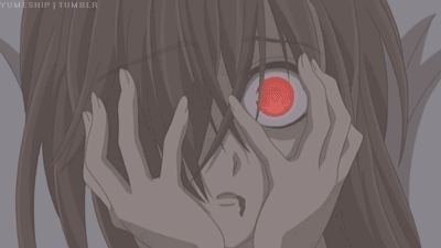 A Close Up Of A Person Covering Their Face With Their Hands With A Red Eye GIF