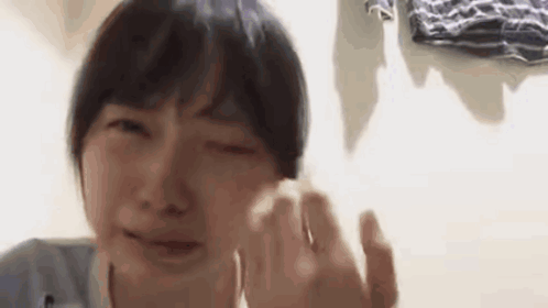 A Close Up Of A Person Crying With Their Eyes Closed . GIF