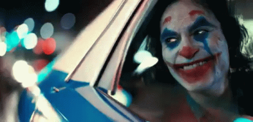 A Close Up Of A Person Dressed As The Joker In A Car . GIF