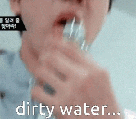 A Close Up Of A Person Drinking Dirty Water From A Glass GIF