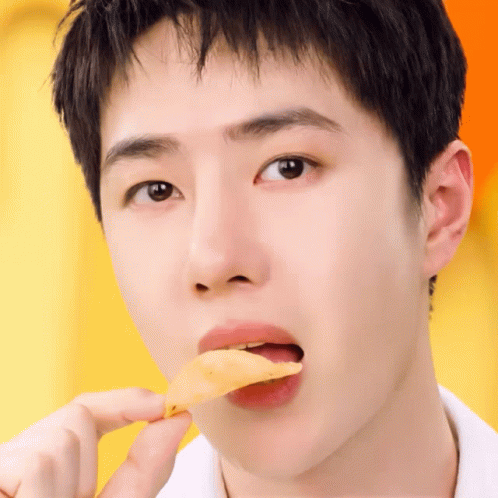 A Close Up Of A Person Eating A Slice Of Food GIF