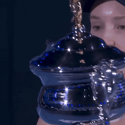 A Close Up Of A Person Holding A Blue Container With A Gold Handle GIF