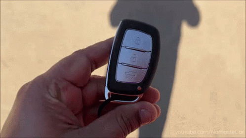 A Close Up Of A Person Holding A Car Key With Youtube.com/namastecar Written On The Bottom GIF