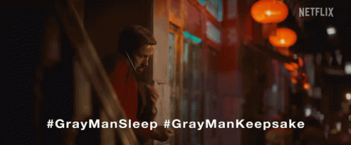 a close up of a person holding a gray man sleep necklace