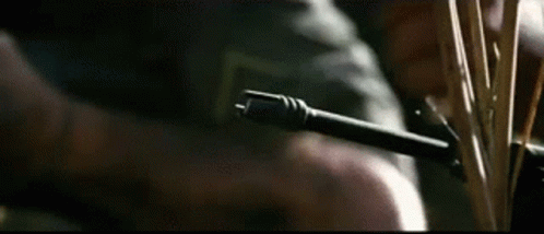 a close up of a person holding a gun and a knife .