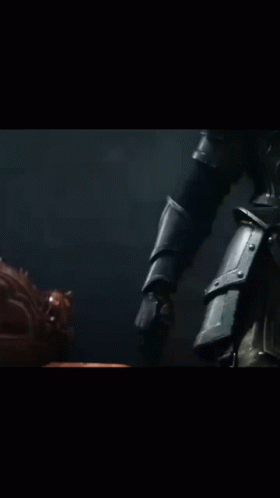 a close up of a person holding a gun in a dark room
