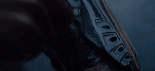 A Close Up Of A Person Holding A Gun In Their Hand . GIF