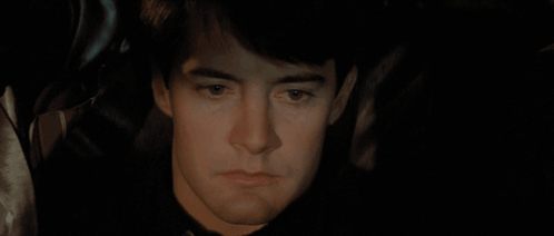A Close Up Of A Person Holding A Knife In Their Mouth GIF