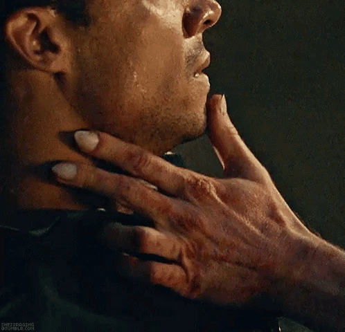 A Close Up Of A Person Holding A Man 'S Neck With Their Hand . GIF