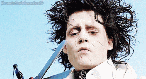A Close Up Of A Person Holding A Pair Of Scissors With The Words " There Is In The Darkness Tumblr " Above Them GIF